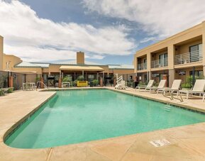 Relaxing outdoor pool with lounge chairs at Sonesta Select Scottsdale At Mayo Clinic Campus.