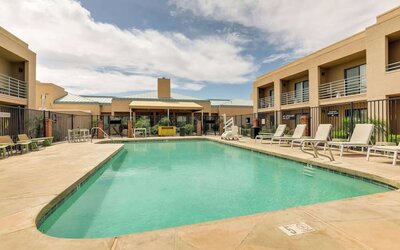 Relaxing outdoor pool with lounge chairs at Sonesta Select Scottsdale At Mayo Clinic Campus.