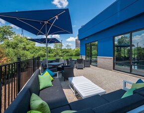 Terrace with ample seats perfect for coworking at Hampton Inn Detroit Southfield.
