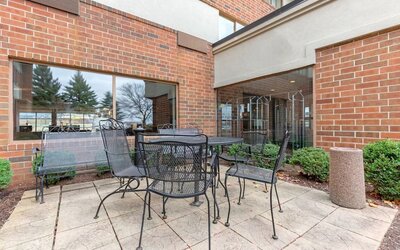 Outdoor terrace with seating at Holiday Inn Express Chicago - Downers Grove.