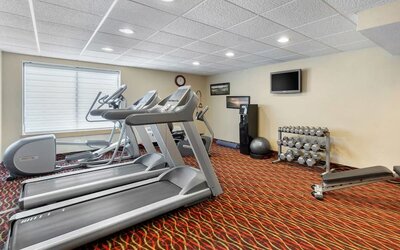 Well equipped fitness center at Holiday Inn Express Chicago - Downers Grove.