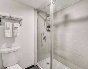 Private guest bathroom with shower at Radisson Hotel Schaumburg.
