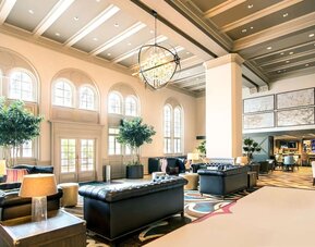 Hotel lobby with comfortable seating and workspace, perfect for coworking at Hilton Baton Rouge Capitol Center.