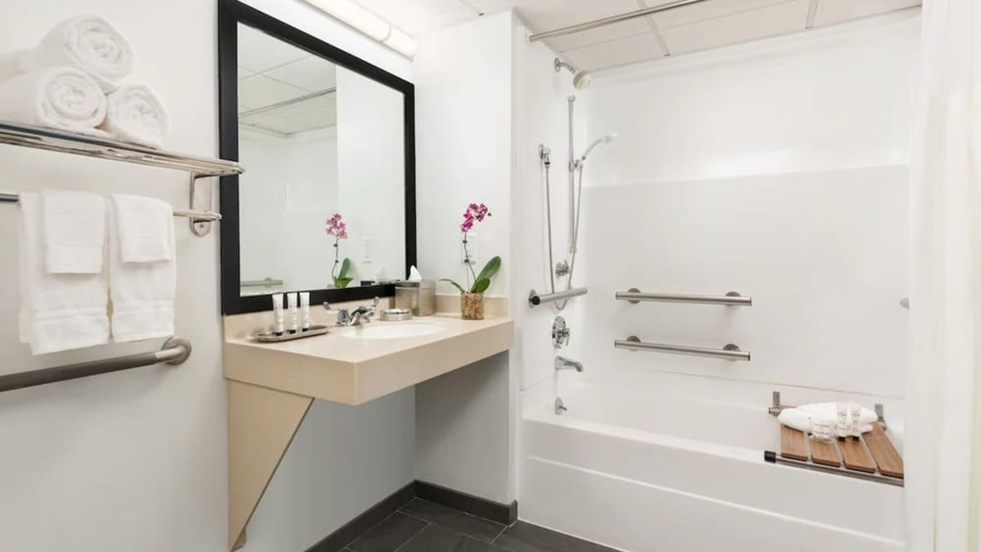 Guest bathroom with shower and tub at Hotel Studio Allston.