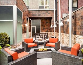 Cozy coworking space with fire pit at Hilton Garden Inn New York/West 35th Street.
