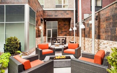 Cozy coworking space with fire pit at Hilton Garden Inn New York/West 35th Street.
