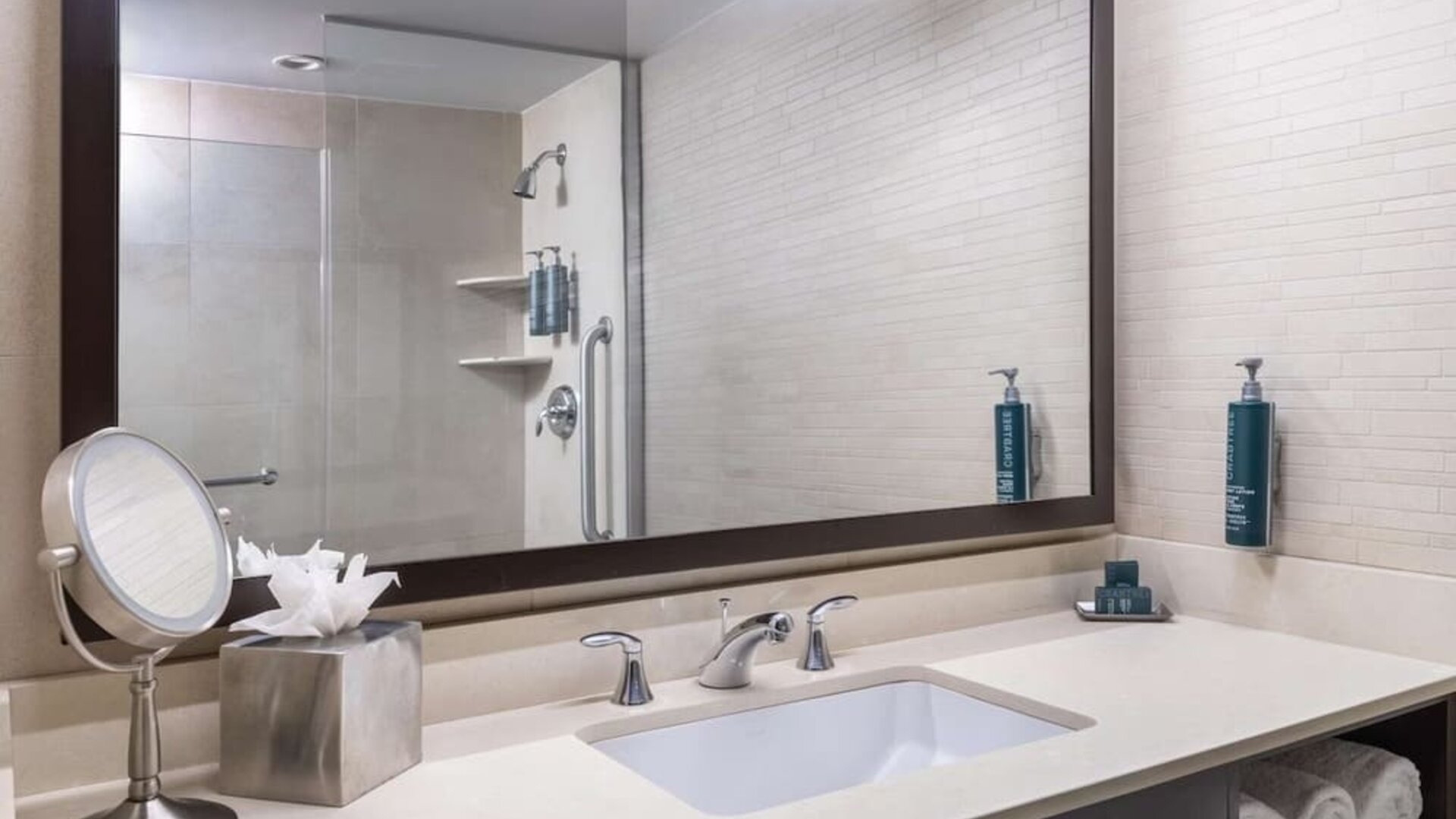 Guest bathroom with shower at Hilton New York Fashion District.