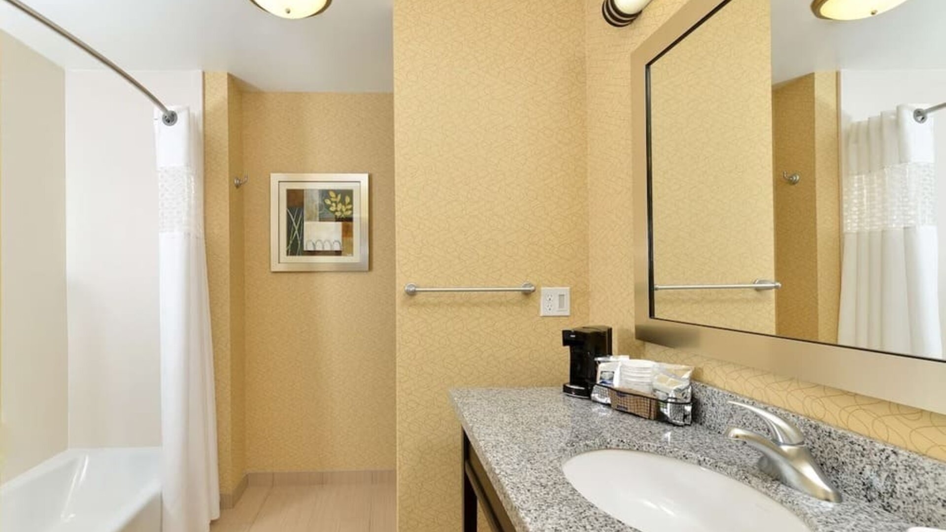 Private guest bathroom with combined shower and tub at Hampton Inn Iowa City/University Area.