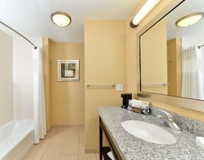 Private guest bathroom with combined shower and tub at Hampton Inn Iowa City/University Area.