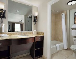 Private guest bathroom with combined shower and tub at Homewood Suites By Hilton Shreveport / Bossier City, LA.