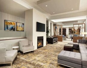Lobby lounge area with fireplace at DoubleTree By Hilton Hartford - Bradley Airport.