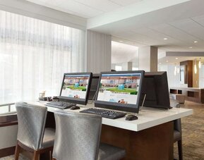 Business center with computers, printer and ergonomic chairs at DoubleTree By Hilton Hartford - Bradley Airport.