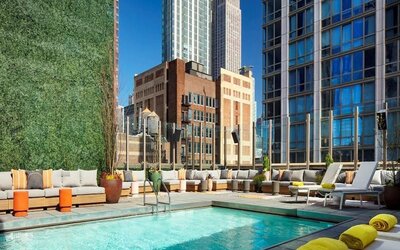 Stunning outdoor pool surrounded by skyscrapers at Royalton Park Avenue.