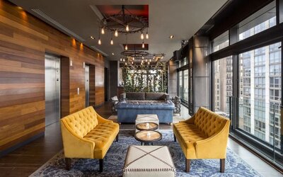 Lounge and coworking area beside elevators at Royalton Park Avenue.