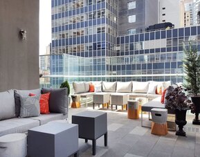 Terrace with ample seats perfect for coworking at The Bernic Hotel New York City, Tapestry Collection By Hilton.