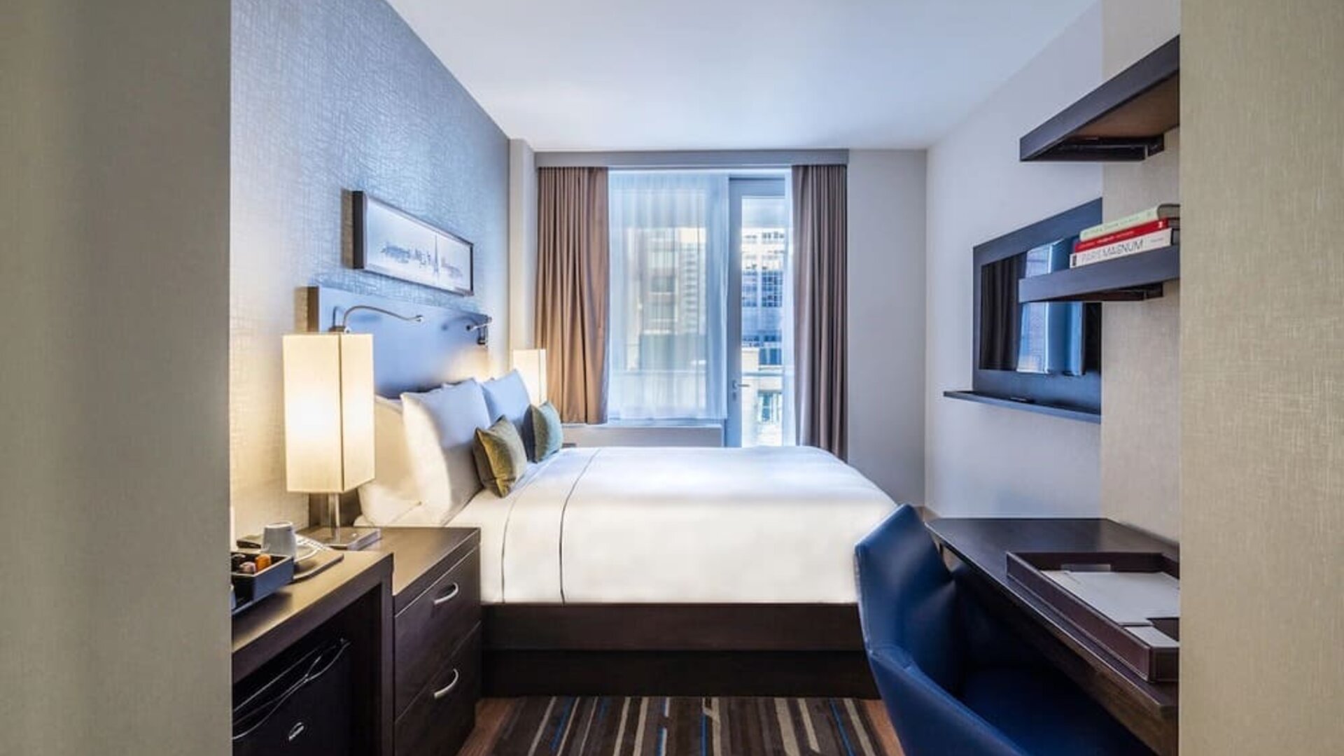 Day use room with work desk and balcony at The Bernic Hotel New York City, Tapestry Collection By Hilton.
