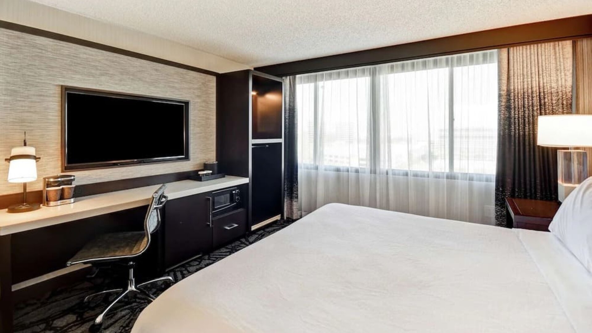 Day use room with work desk and natural light at Embassy Suites By Hilton Santa Clara Silicon Valley.