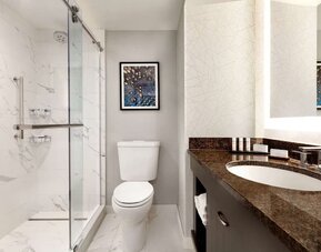 Private guest bathroom with shower at Embassy Suites By Hilton Santa Clara Silicon Valley.