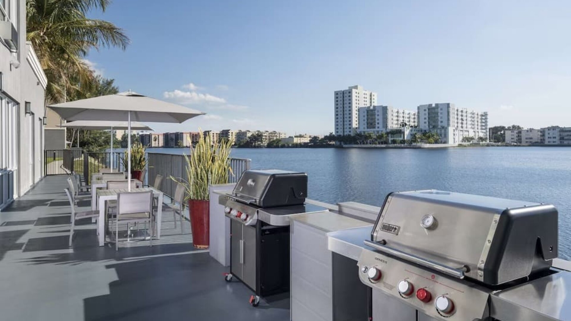 Grill and picnic area with a great view of the lagoon at Homewood Suites By Hilton Miami Airport-Blue Lagoon.