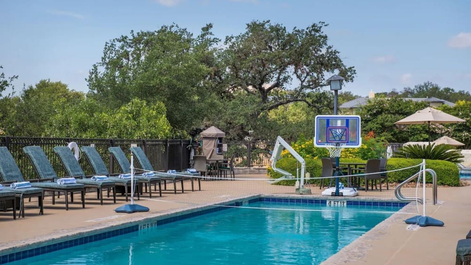 One of the 3 outdoor pools with loungers at Hilton San Antonio Hill Country.