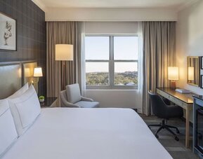 Day use room with work desk and natural light at Hilton San Antonio Hill Country.