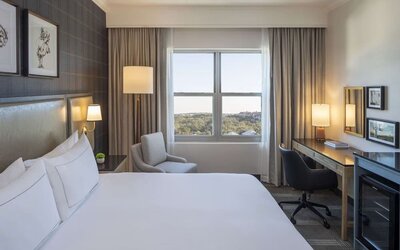 Day use room with work desk and natural light at Hilton San Antonio Hill Country.