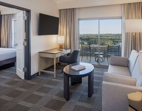 Day use room with living area and balcony at Hilton San Antonio Hill Country.