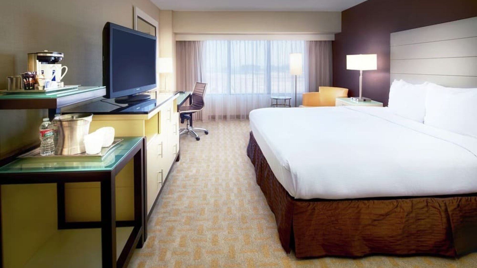 Day use room with work desk and natural light at Hilton Los Angeles Airport.
