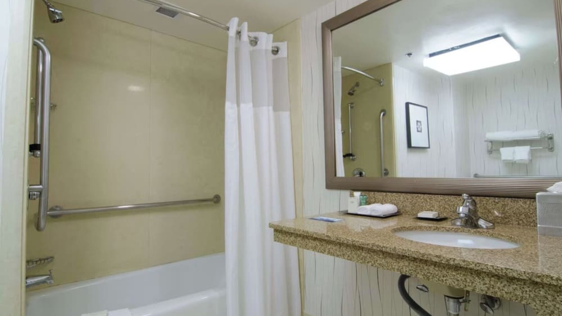 Guest bathroom with shower and tub at Hilton Los Angeles Airport.