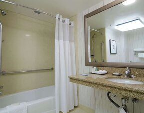 Guest bathroom with shower and tub at Hilton Los Angeles Airport.