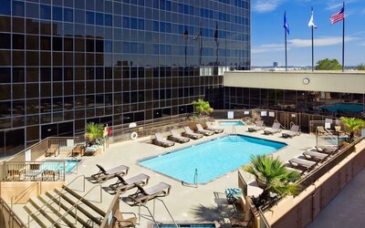 Stunning outdoor pool surrounded by loungers at Hilton Los Angeles Airport.