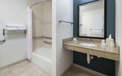 Private guest bathroom with combined shower and tub at Hilton Garden Inn Dothan.