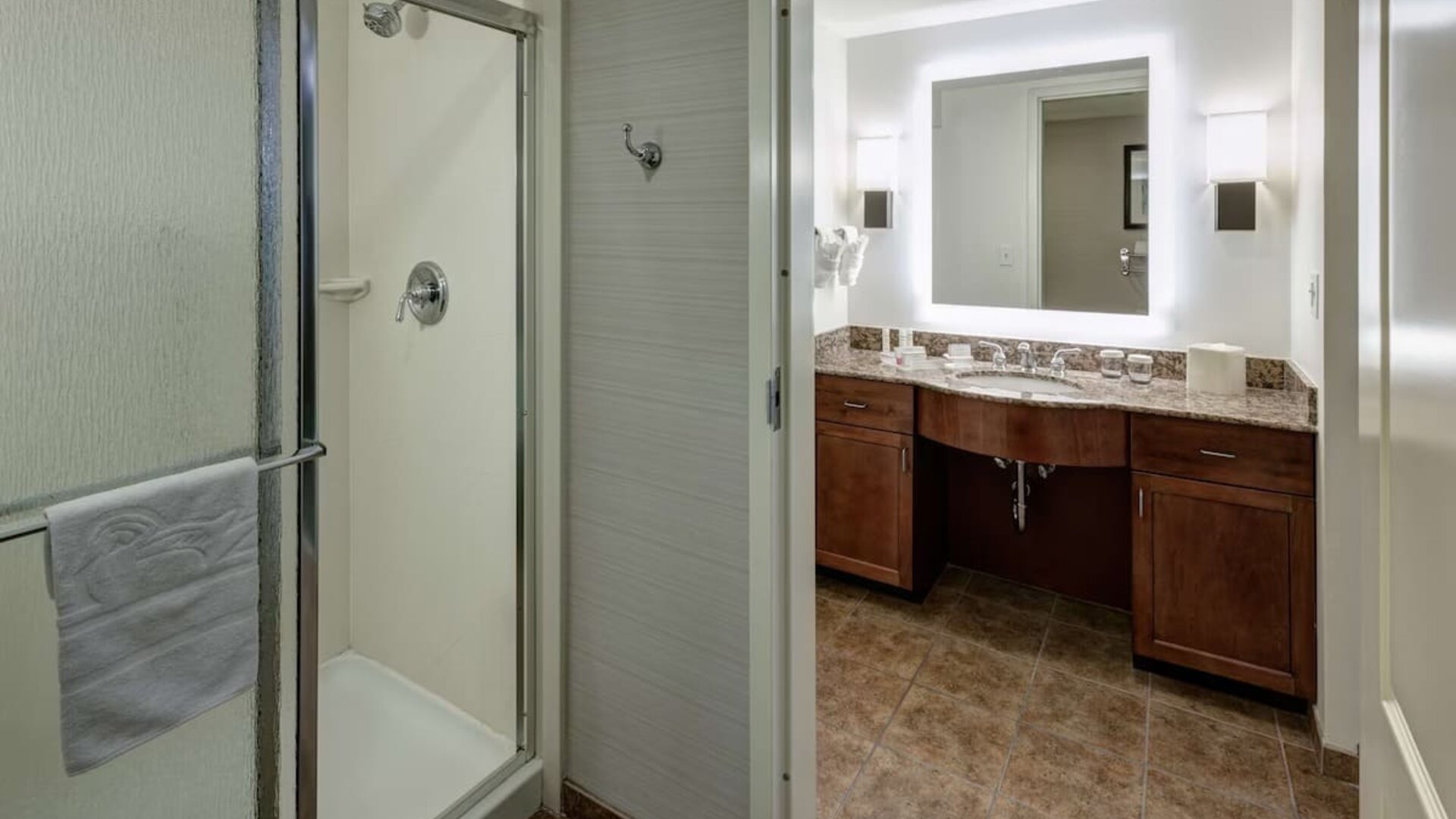 Private guest bathroom with shower and free toiletries at Homewood Suites By Hilton Denton.