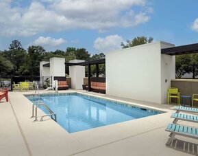 Stunning outdoor pool with seating area at Home2 Suites By Hilton Charleston Airport/Convention Center.