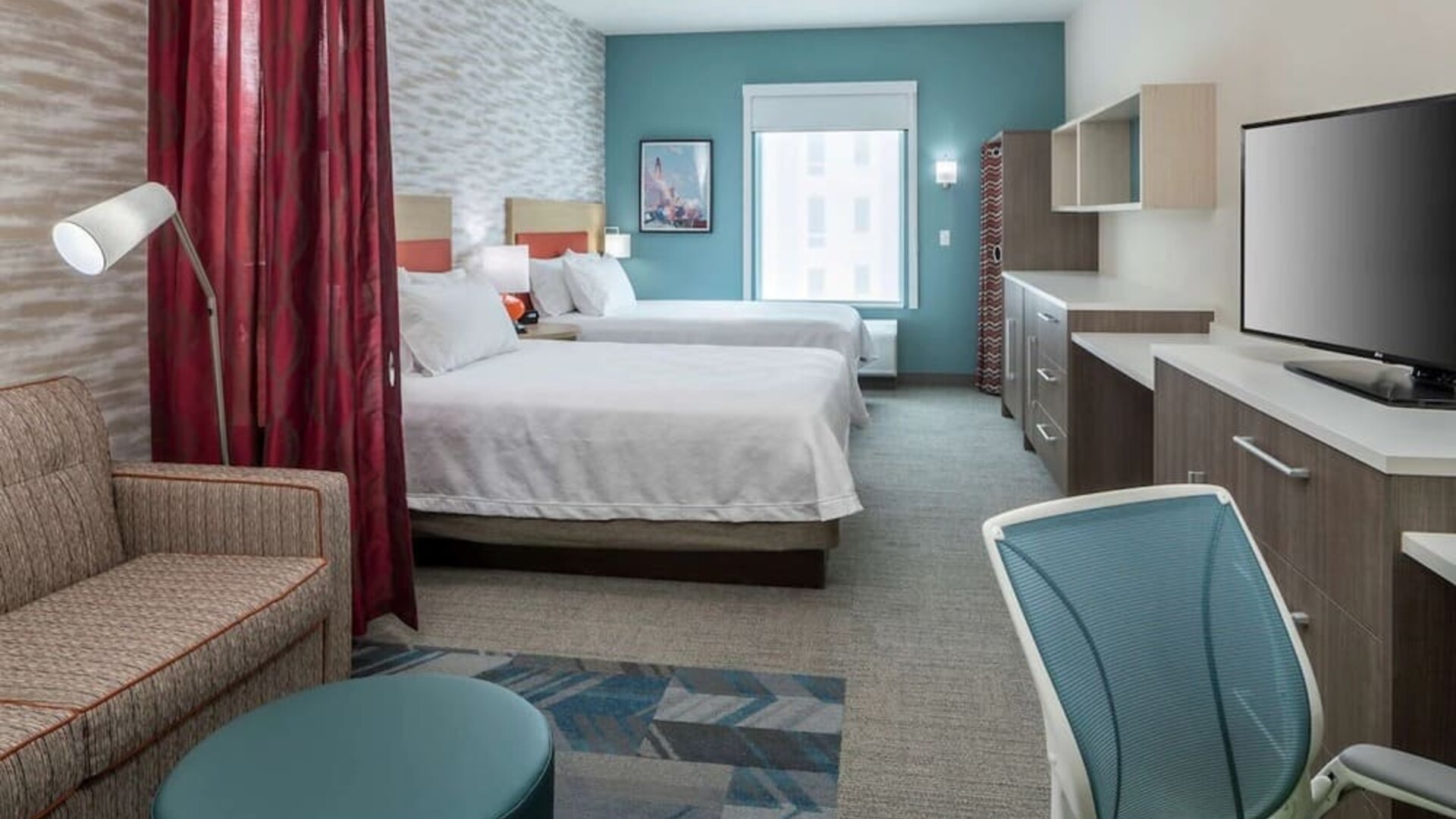 Day use twin room with work desk and lounge area at Home2 Suites By Hilton Cape Canaveral Cruise Port.