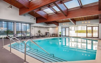 Relaxing indoor pool with lounge chairs at DoubleTree By Hilton Washington DC North/Gaithersburg.