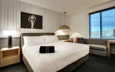 Day use room with sofa and work desk at The Rose Hotel Chicago O’Hare, Tapestry Collection By Hilton.