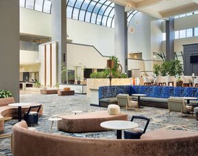 Lobby lounge area at Embassy Suites By Hilton West Palm Beach Central.