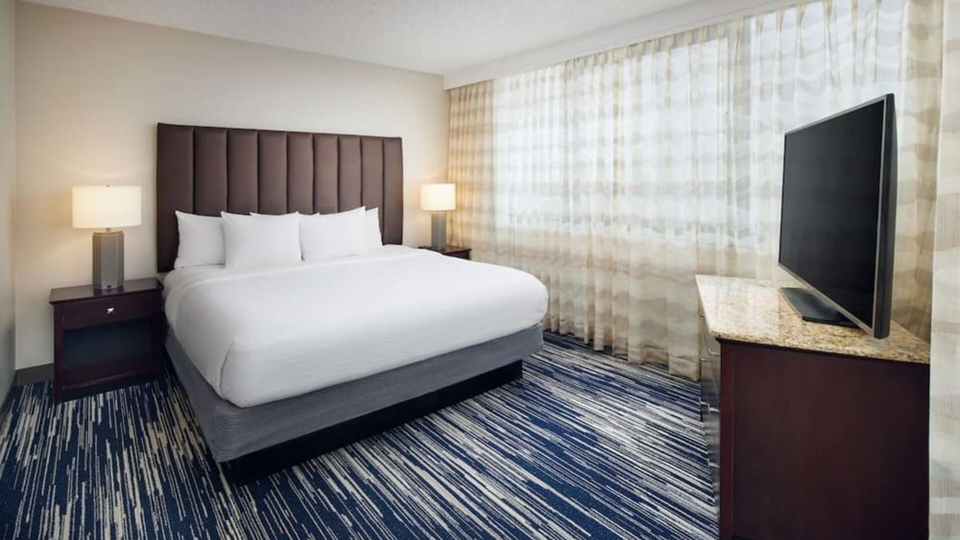 King bed at Embassy Suites By Hilton West Palm Beach Central.