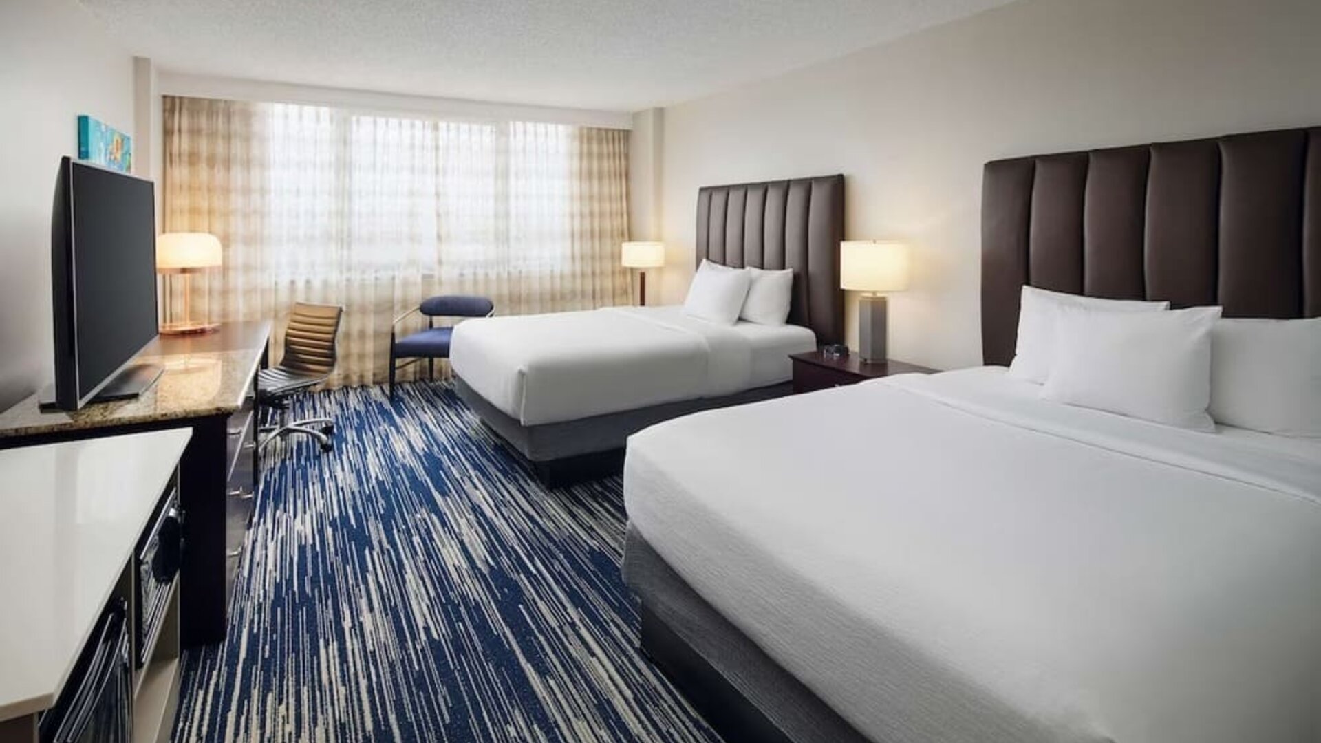 Bright and spacious day use twin room with work desk at Embassy Suites By Hilton West Palm Beach Central.