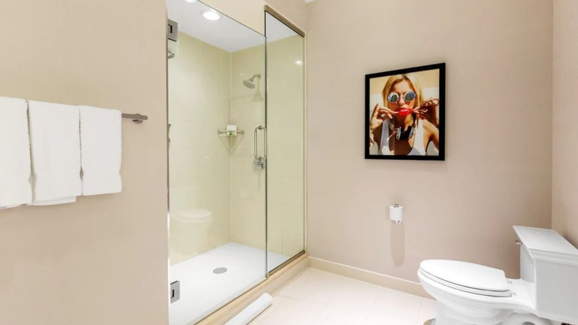 Private guest bathroom with shower and free toiletries at The Chicago Hotel Collection - Magnificent Mile.