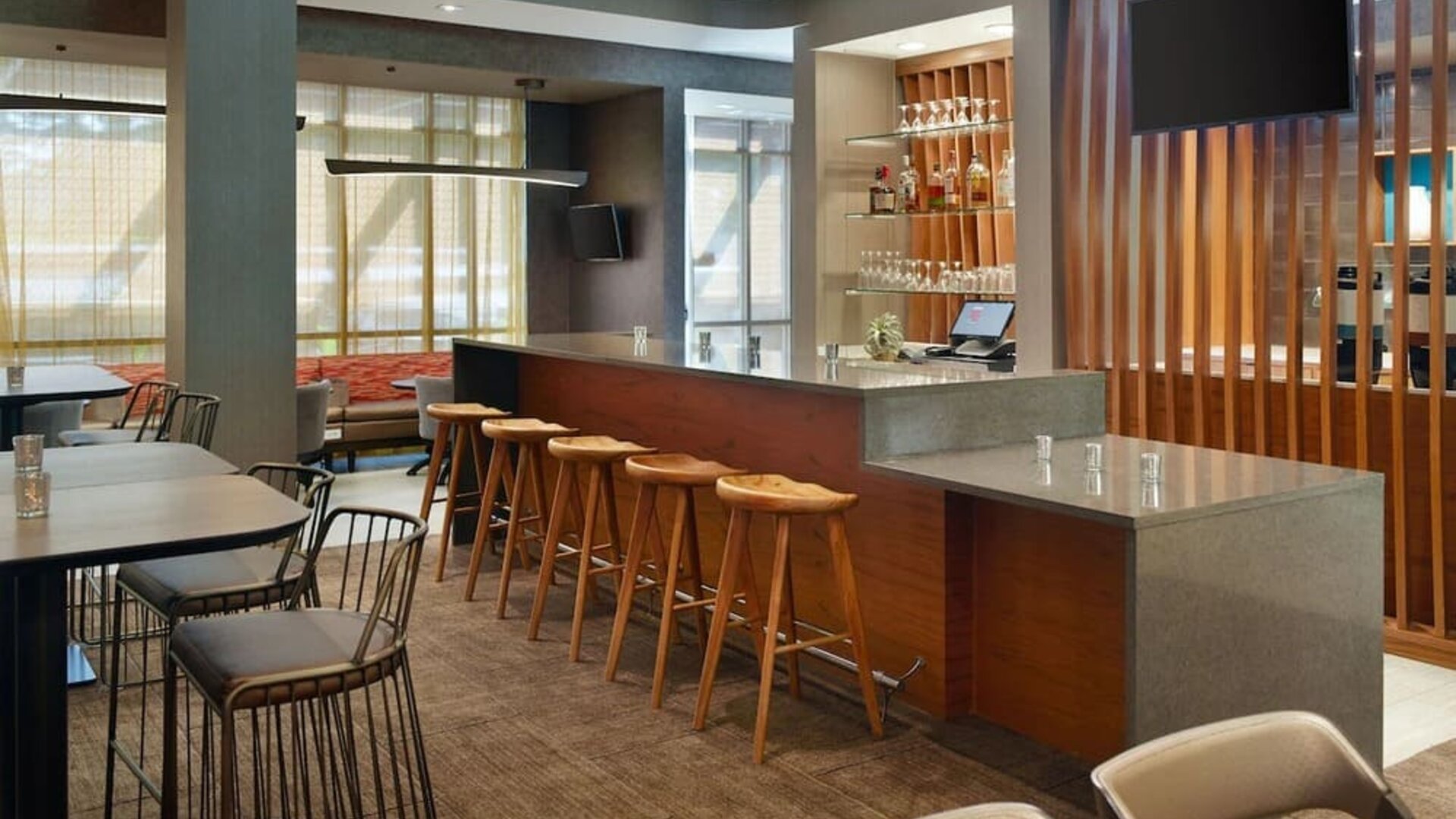 On-site bar with lounge seating and workspace, perfect for coworking at 	SpringHill Suites Atlanta Northwest.