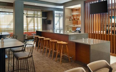 On-site bar with lounge seating and workspace, perfect for coworking at 	SpringHill Suites Atlanta Northwest.