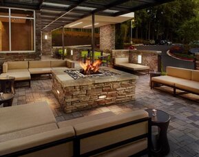 Patio with lounge seating and fire pit at 	SpringHill Suites Atlanta Northwest.