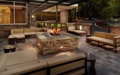 Patio with lounge seating and fire pit at 	SpringHill Suites Atlanta Northwest.