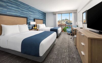 Day use twin room with work desk and floor to ceiling window at Hotel Caza.