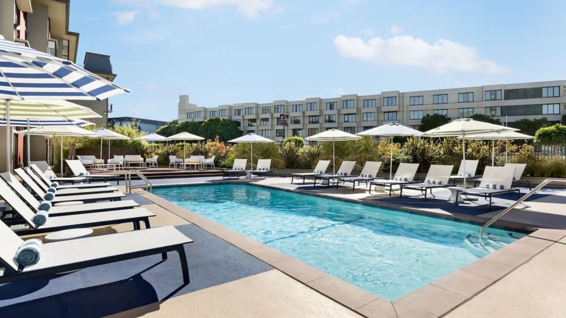Outdoor pool with lounge chairs at Hotel Caza.