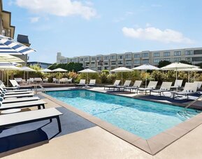 Outdoor pool with lounge chairs at Hotel Caza.