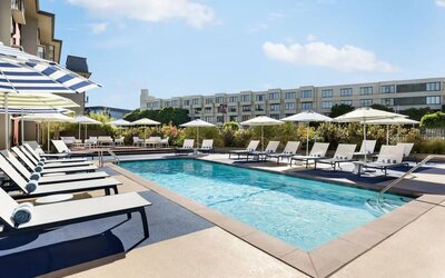 Outdoor pool with lounge chairs at Hotel Caza.