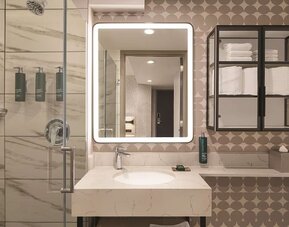 Private guest bathroom with shower and free toiletries at DoubleTree By Hilton New York Midtown Fifth Ave.